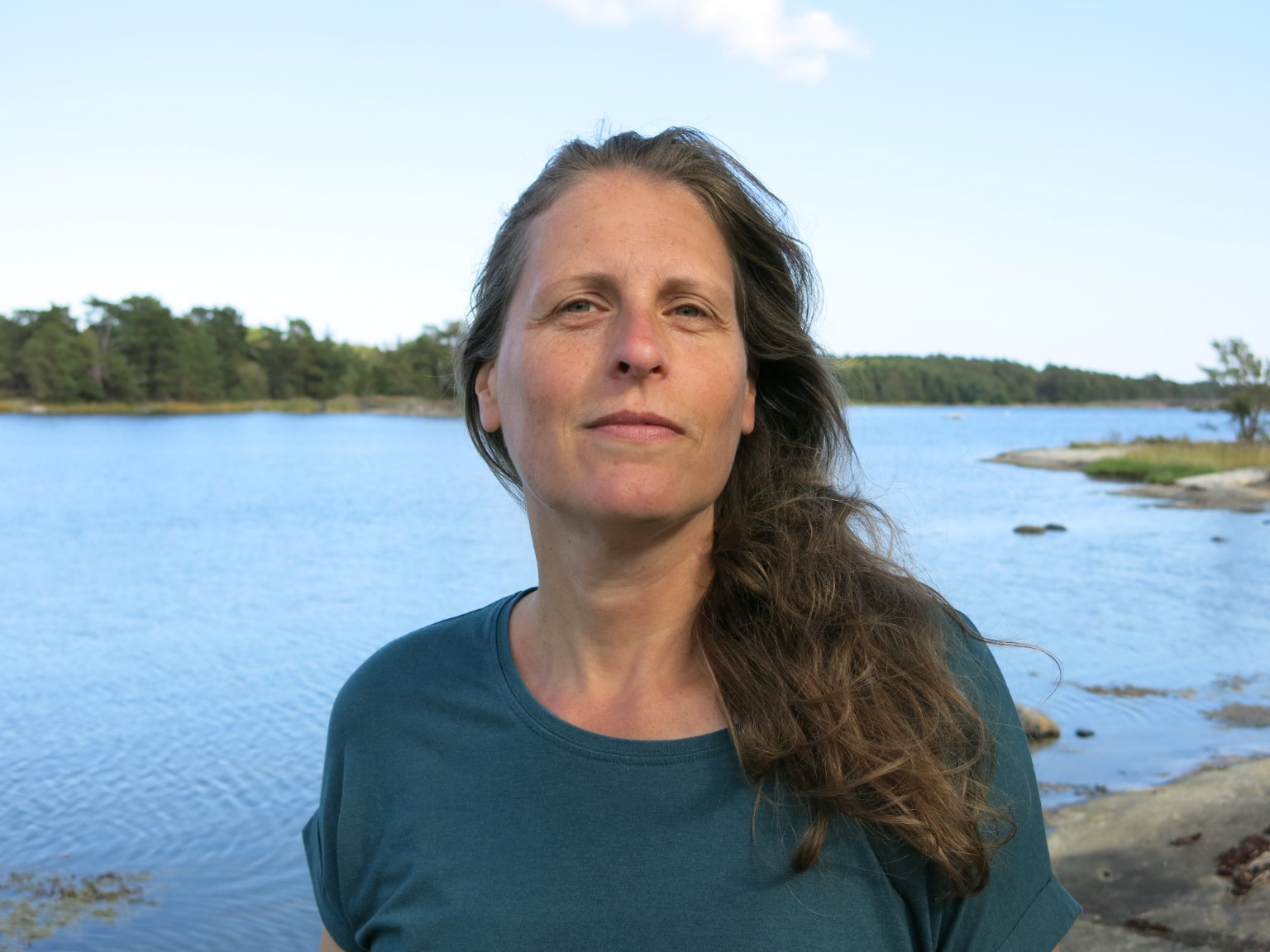 Porträt von Anne Nørdby am Wasser mit Pferdeschwanz auf der rechten Seite